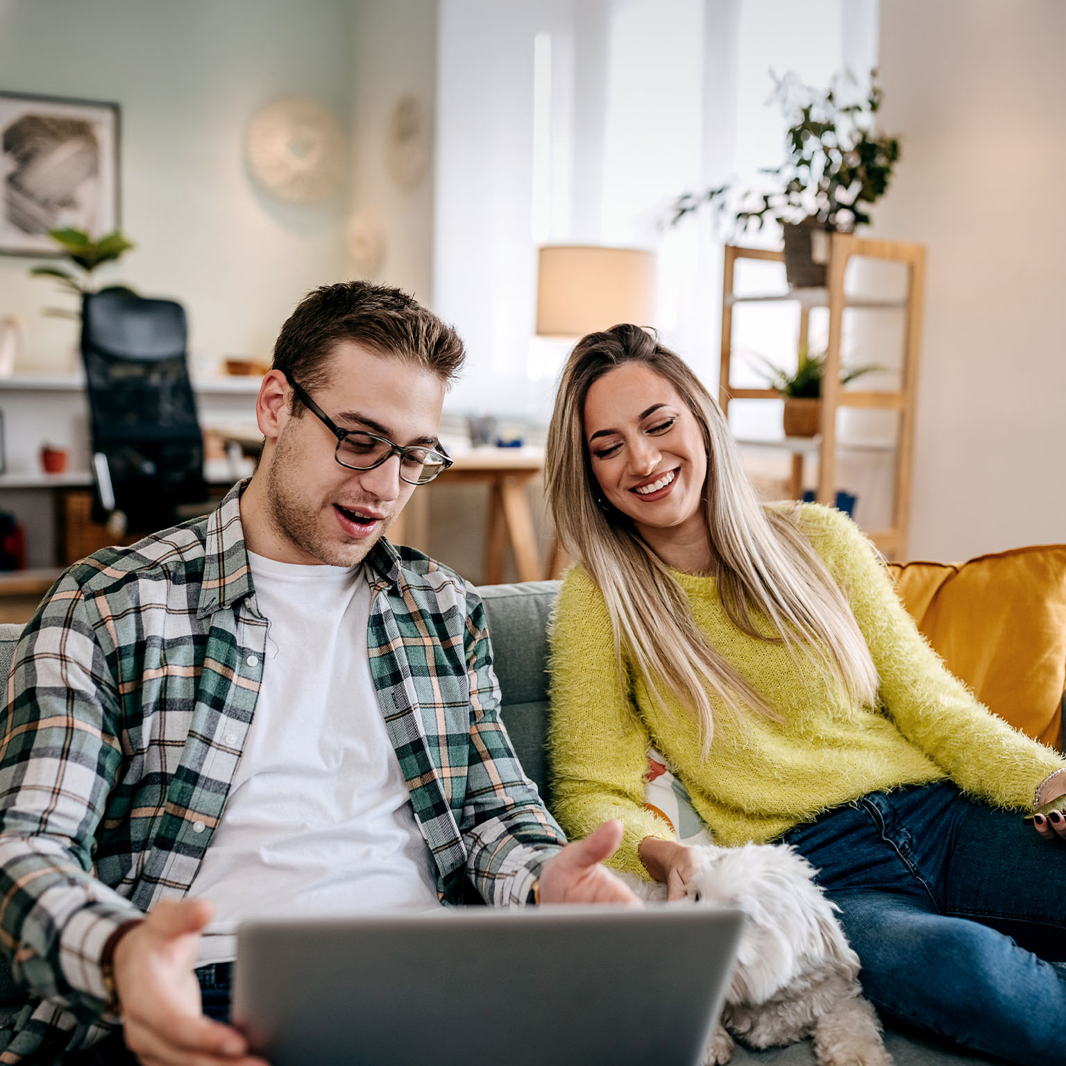Modern couple with their pet dog at home