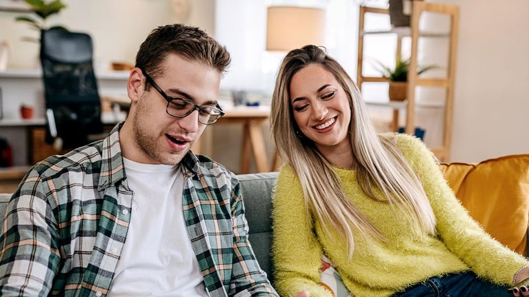 Modern couple with their pet dog at home
