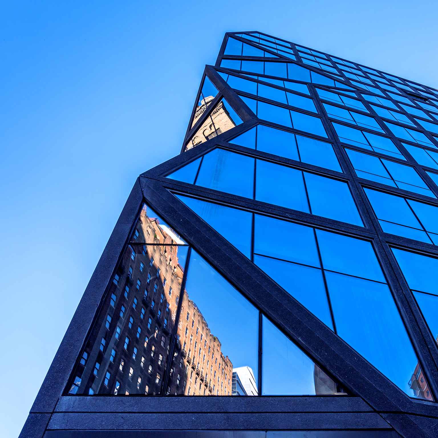 Looking up at a hig-hrise residential tower 