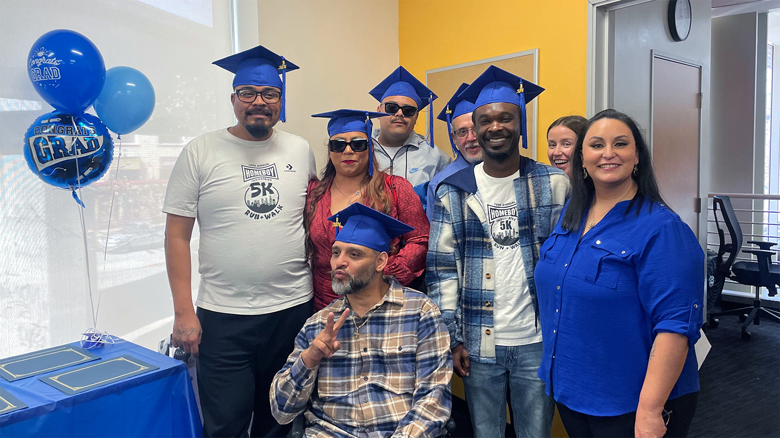 The first cohort of Homeboy's new dog grooming business celebrating their job training completion