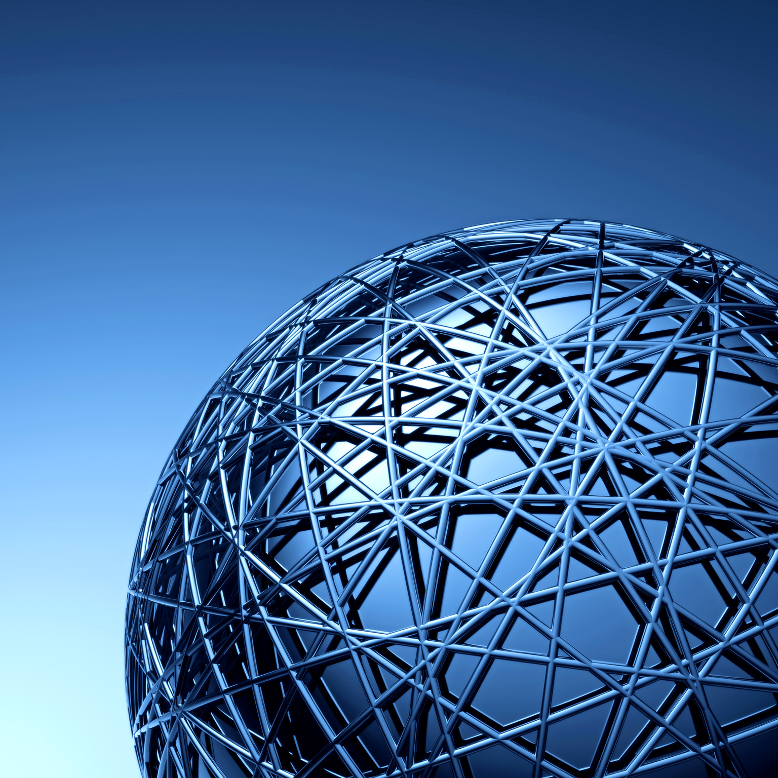 A close-up view of a large metallic spherical structure made of interwoven beams, creating a complex geometric pattern. 
