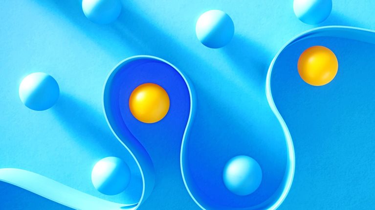 Many spheres separated by a curved wall.