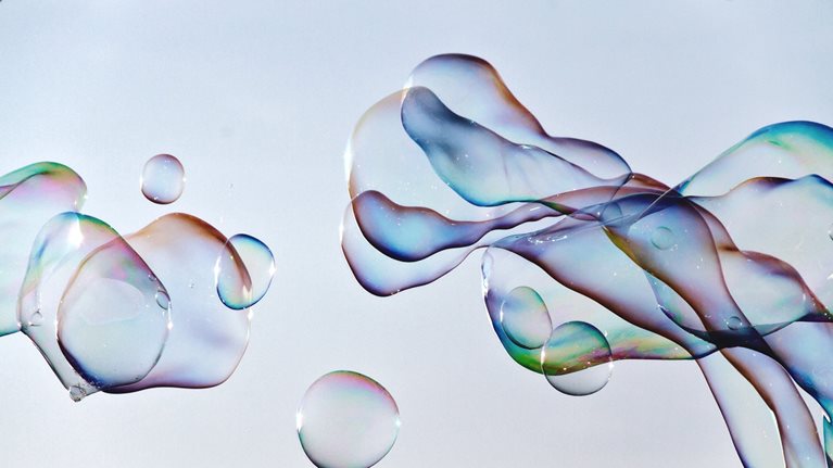 Close-up of bubbles against blue sky
