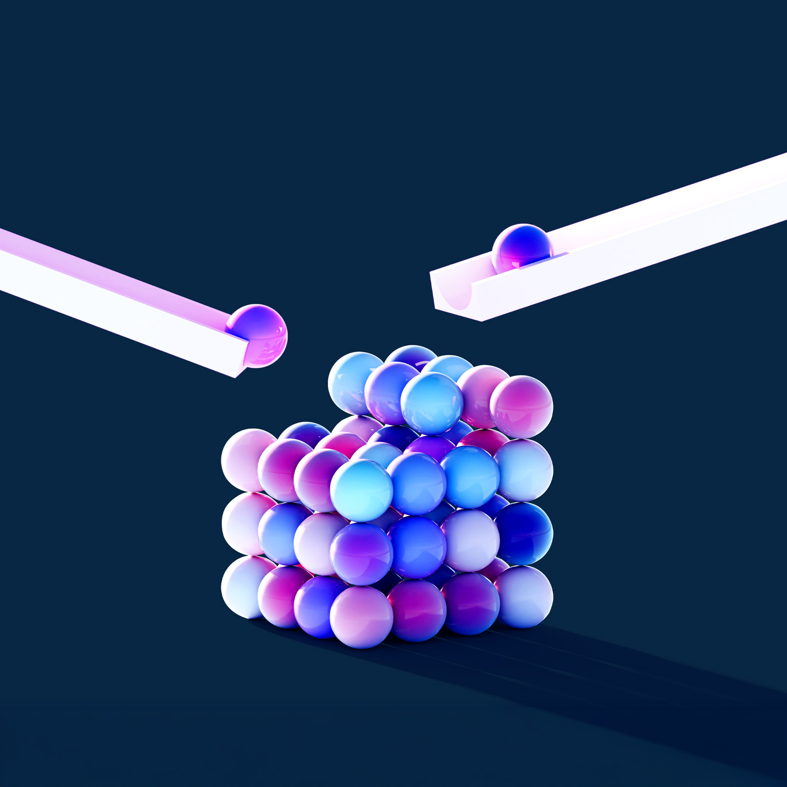 Two glossy spheres roll down separate white ramps toward a neatly stacked cube made of smaller, colorful balls. The balls are shaded in gradients of blue, purple, and pink against a dark blue background, creating a sleek, modern 3D scene.