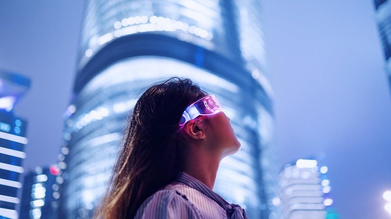 Young businesswoman standing against contemporary financial skyscrapers in the downtown financial district - stock photo