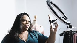 Woman taking selfie with light prop