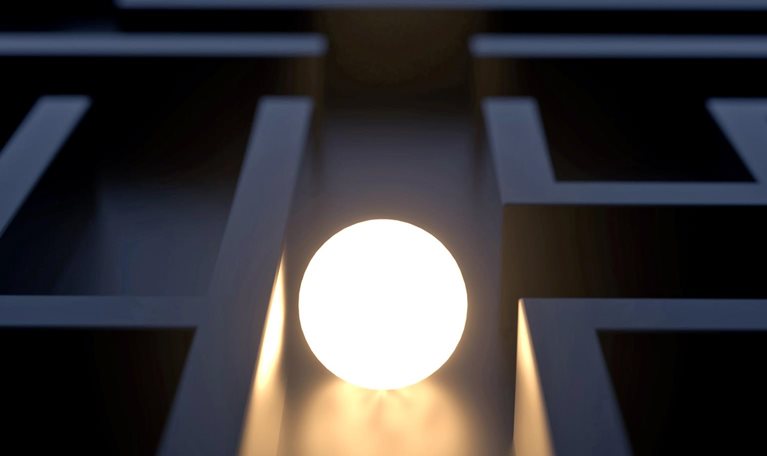 Circular white light shining in the middle of a maze