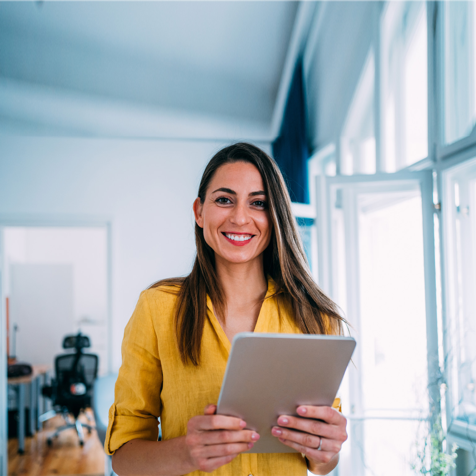 smiling woman holding tablet