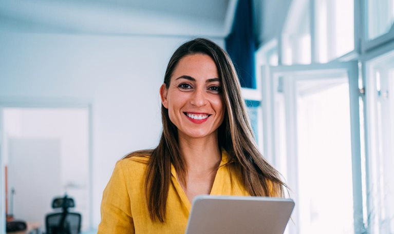 smiling woman holding tablet