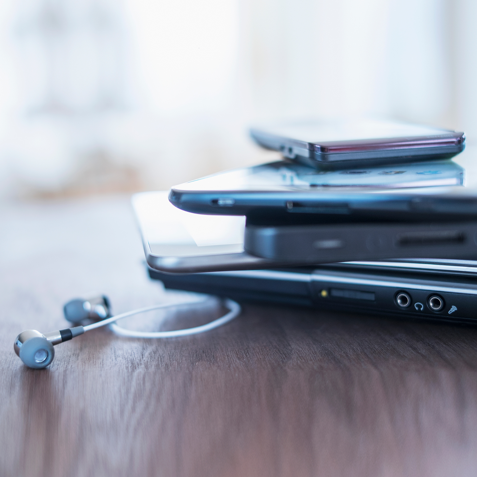USA, New Jersey, Jersey City, Close up of stack of devices on desk - stock photo