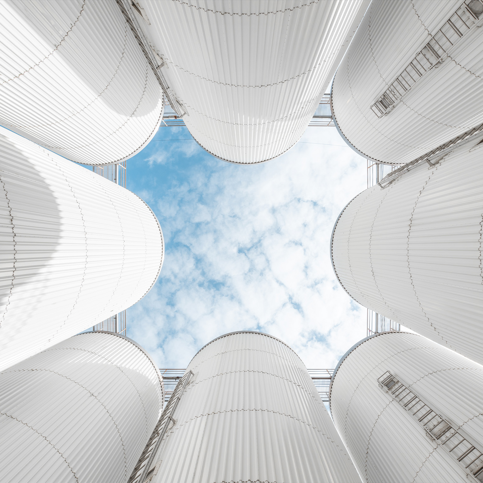 The abstract pattern formed by the storage tanks of the brewery under the blue sky - stock photo