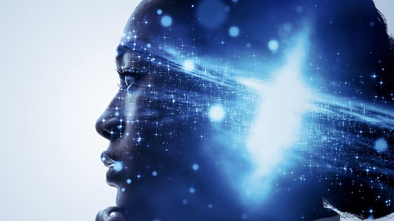 A profile of a woman with her hand up to her chin in a thoughtful pose.  A galaxy bursting with light is superimposed over profile, centered over her mind.
