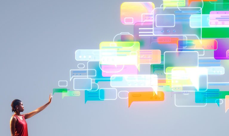 A person reaches into a cascade of colorful message bubbles, symbolizing agentic AI orchestrating empathetic, human-centered customer conversations at scale.