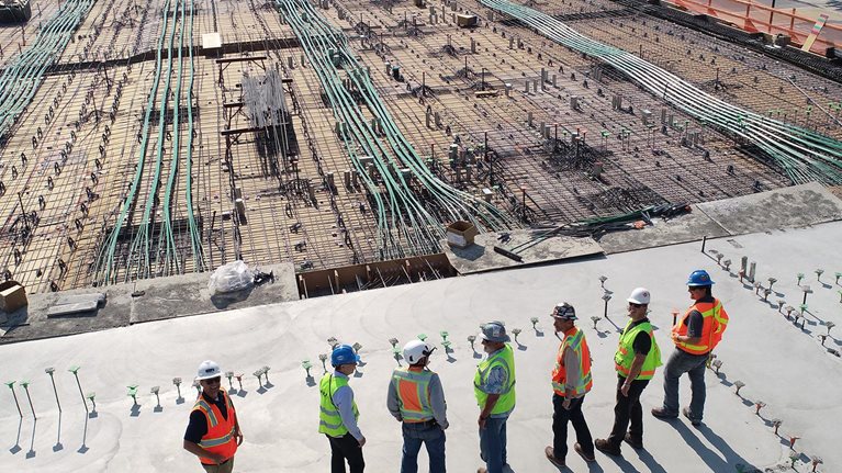construction workers looking out over site