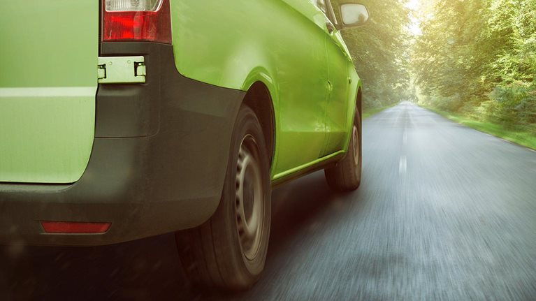 Sustainable freight transport vehicle driving down road