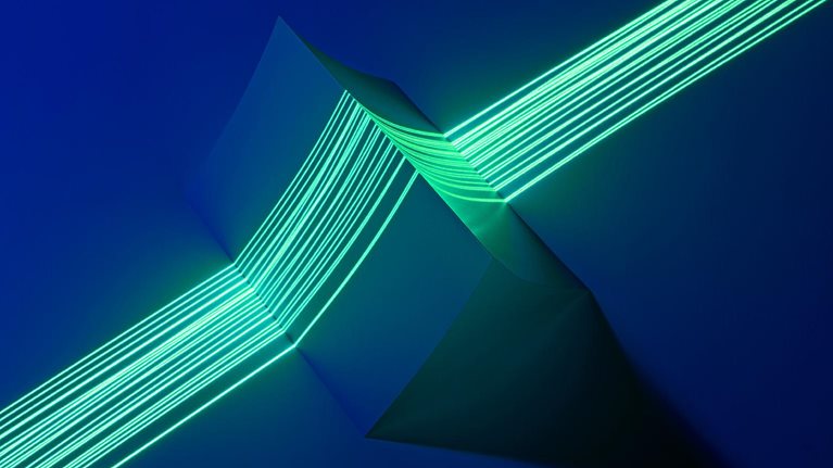 Image of multiple green laser lines coming together to precisely measure a triangle shaped object.