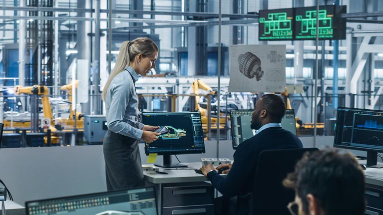 Car Factory: Team of Automotive Engineers Working, Using Computers to Design Advanced 3D Models for High-Tech Engines. Automated Robot Arm Industrial Assembly Line Manufacturing Electric Vehicles - stock photo