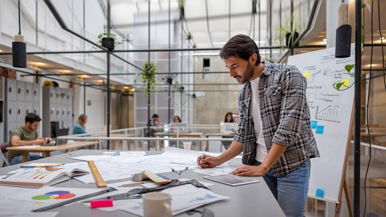 Creative business man working at a coworking space - stock photo