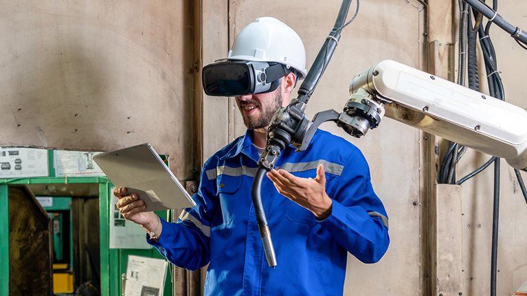 Engineer works with a HoloLens: place a virtual robotic arm into the production line