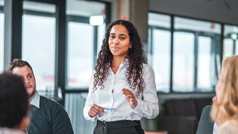 African American Female Manager Explains Business Plans to Team