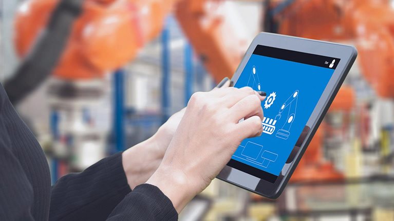 Close up view of a tablet with someone pointing to an image featuring advanced manufacturing technology.