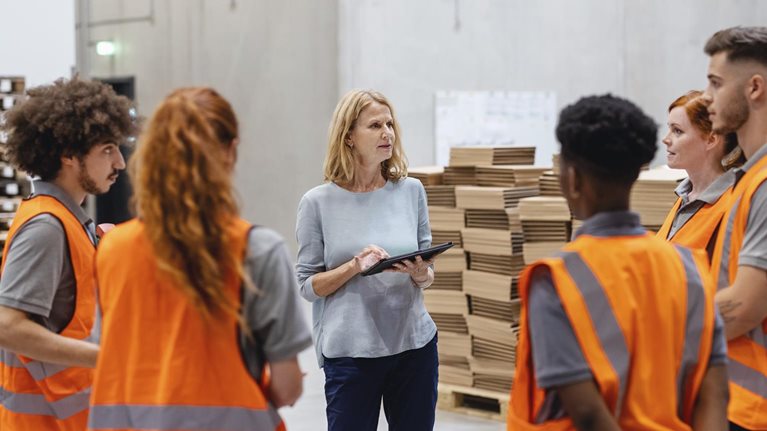 Warehouse manager talking with a team of workers