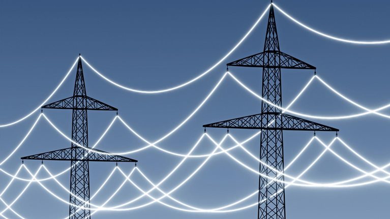 Electricity pylons with glowing power lines to emphasize technology