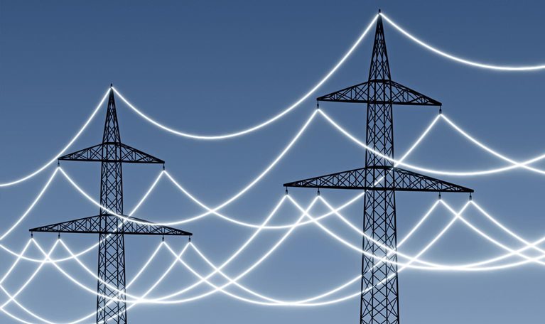 Electricity pylons with glowing power lines to emphasize technology