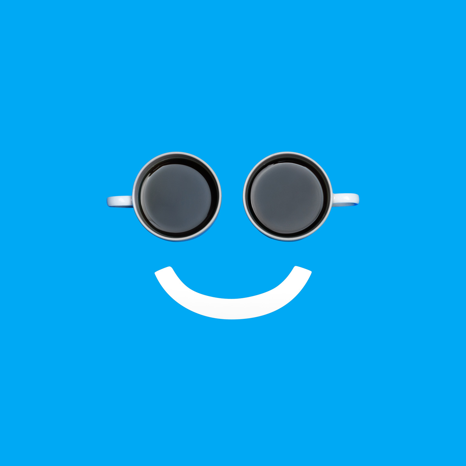  A smiley face with two coffee cups for the eyes and a white line for the mouth. 