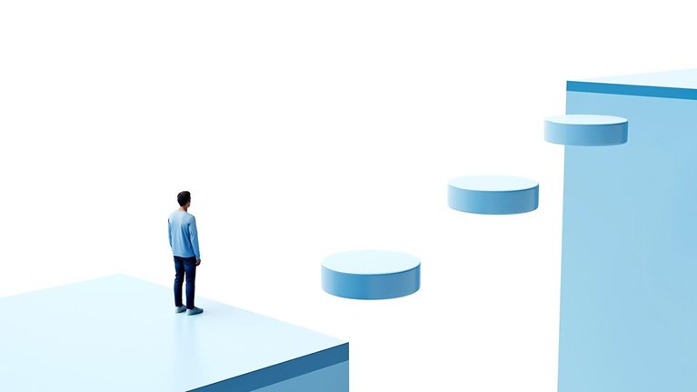 Conceptual image of a person in a blocky 3D environment, standing at the edge of a chasm with floating disks forming a walkway across.