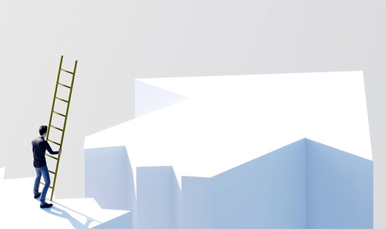 Person holding a ladder while standing near the edge of a gap between elevated surfaces.