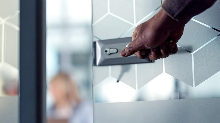 Close up of unrecognizable businessman opening an office door while entering