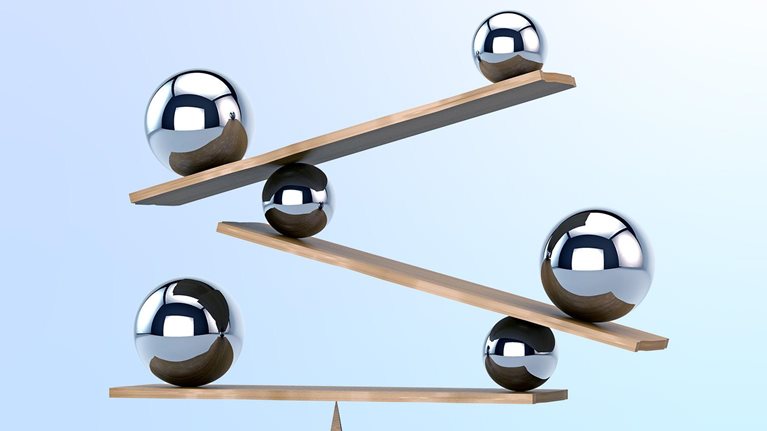 Multilayered balance board with multiple chrome spheres of different sizes creates a dynamic equilibrium.