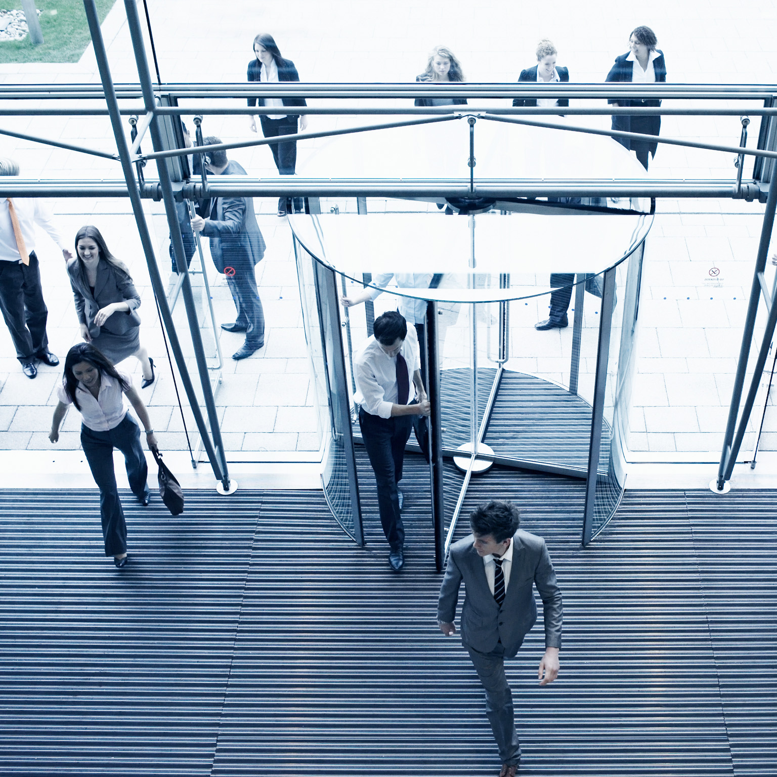 Employees entering their office though multiple doors in the lobby