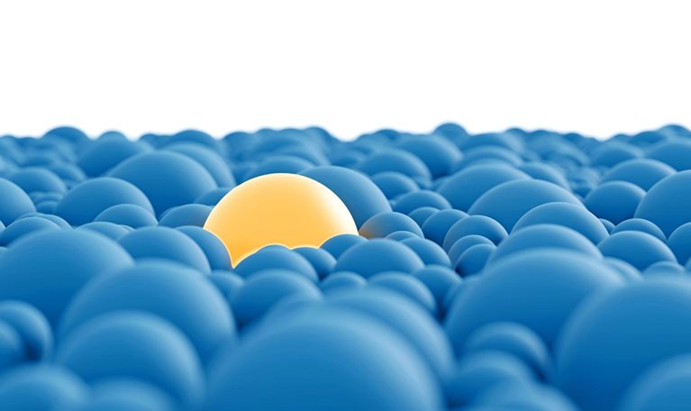 A group of closely clustered blue spheres with a conspicuous, larger yellow sphere in their midst.