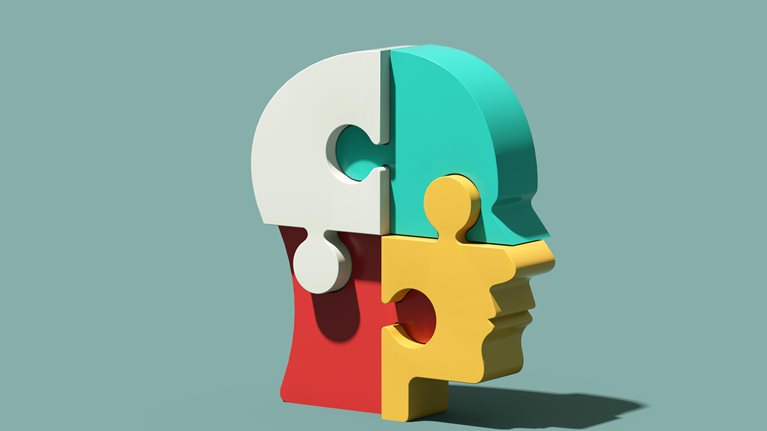 Head made from jigsaw puzzles - stock photo