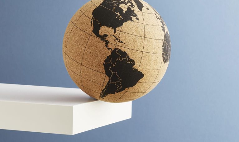 The globe in brown and yellow at the edge of a diving board