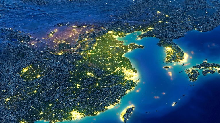 Satellite image of Earth at night with a focus of illumination on Asia