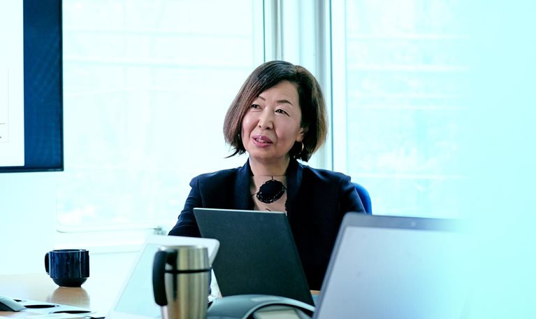 Female business owner talking during meeting in office conference room.