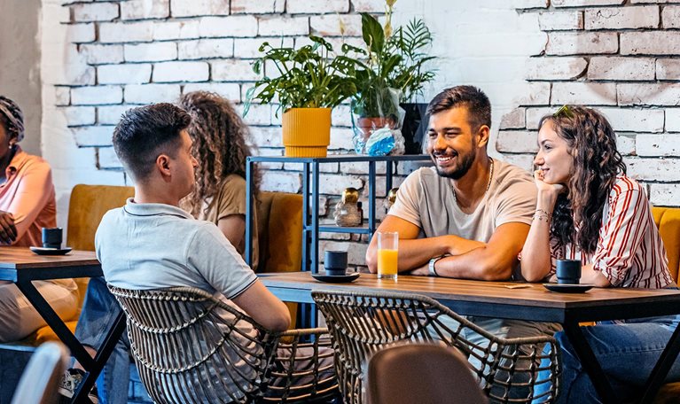 Cafe with guests sitting at tables.