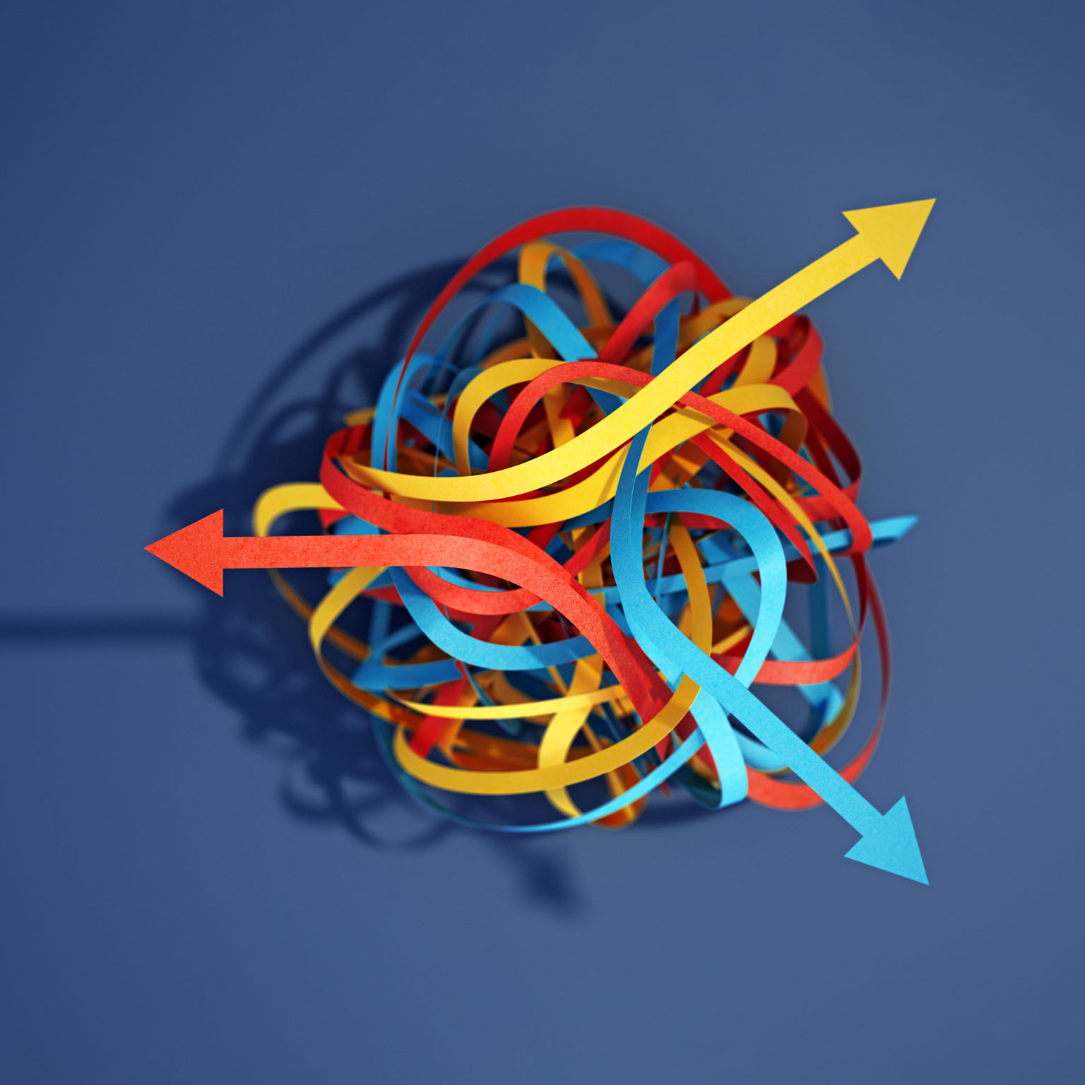 Tangled paper cut blue, yellow and red tapes with arrows pointing different ways