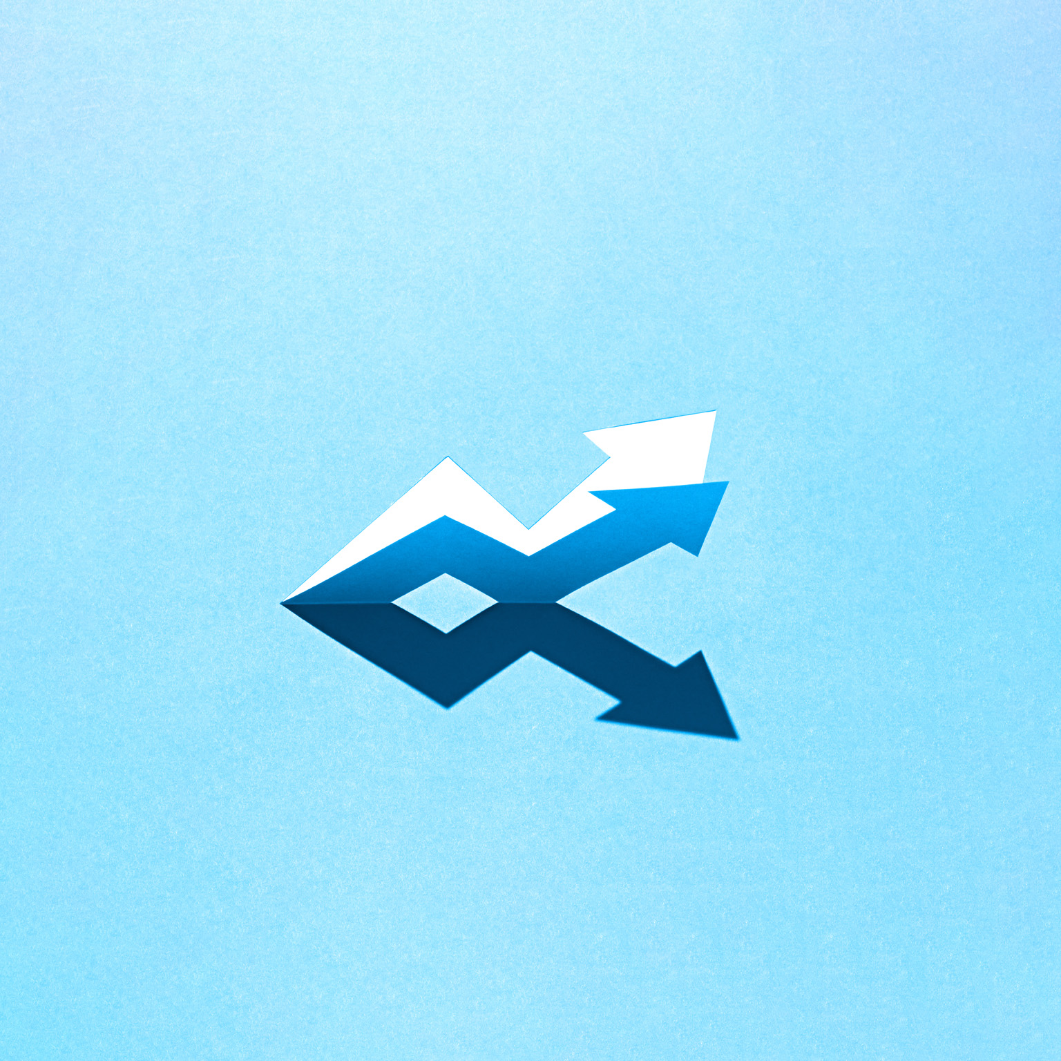 The image shows a pair of contrasting arrows forming a zig-zag pattern on a light blue background. The arrows are made of paper, with one set appearing white and creating a shadow that forms a darker, mirrored reflection.