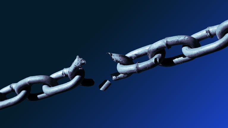 Close-up of metallic chain breaking