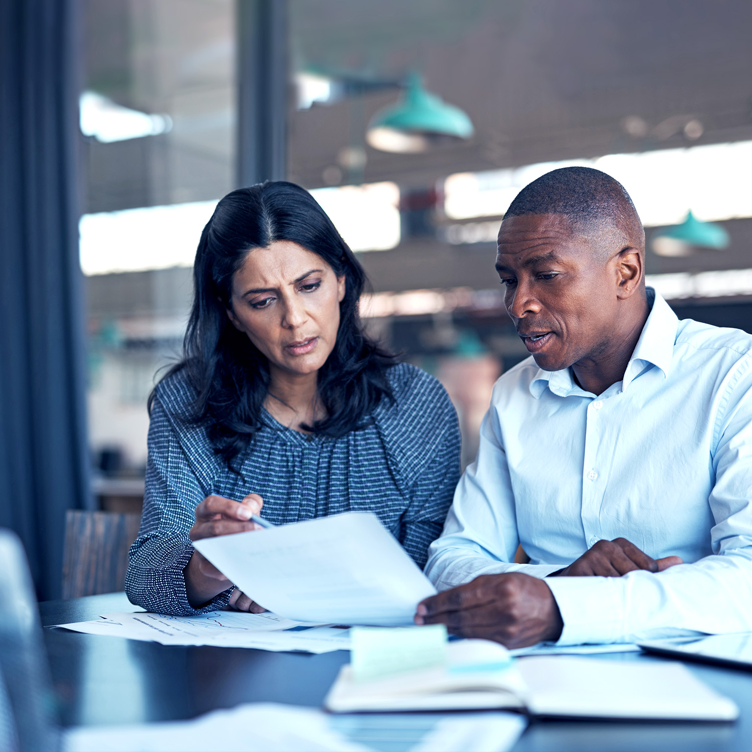 A man and women sit together and review a piece of paper