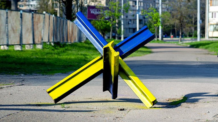 Anti-tank hedgehogs on the sidewalks of the city of Kyiv painted under the national ensign of Ukraine