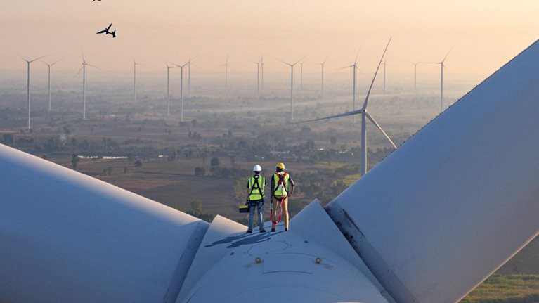 Two rope access technicians working on higher wind turbine blades