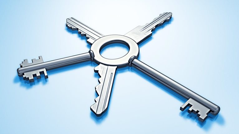 Five metallic keys with different bits joined together on single central ring, arranged like spokes set against a light blue background.