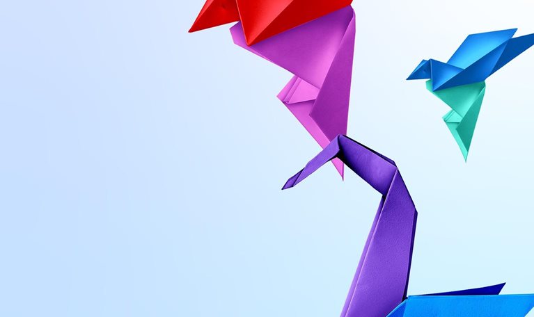 Three origami birds on a light blue background