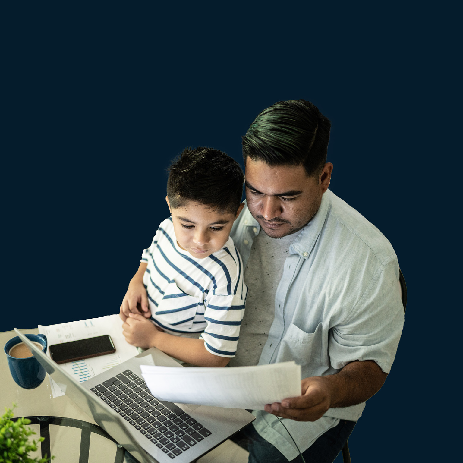 Father working with his son using laptop at home