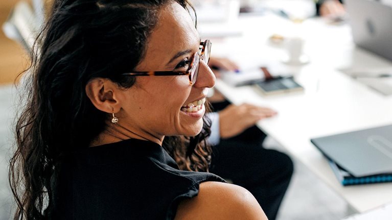 Closeup of Hispanic businesswoman in office meeting
